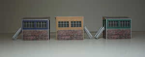 3 N Gauge signal boxes of different colours viewed from different angles