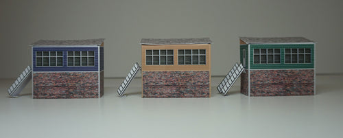 3 N Gauge signal boxes of different colours viewed from the front