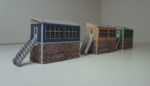 3 N Gauge signal boxes of different colours viewed from the side